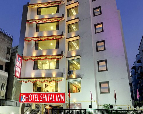 Hotel Shital Inn exterior with red entrance sign in the evening