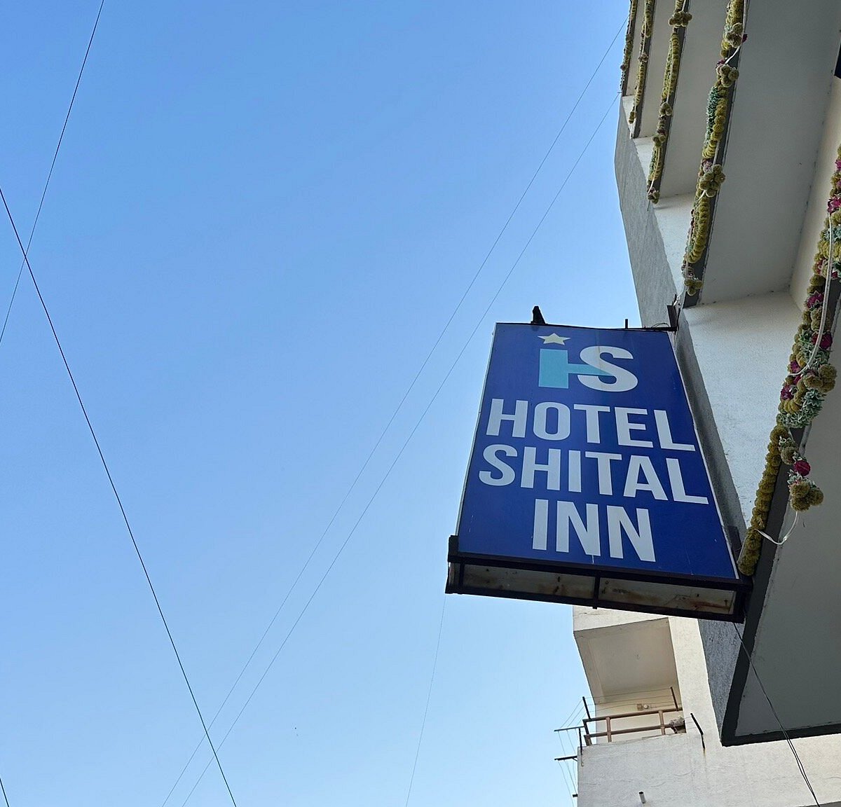 Hotel Shital Inn exterior sign against the Ahmedabad sky
